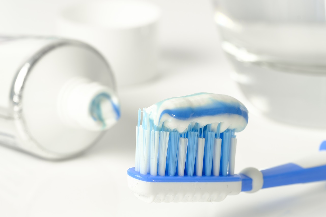 A close up of a toothbrush and toothpaste.