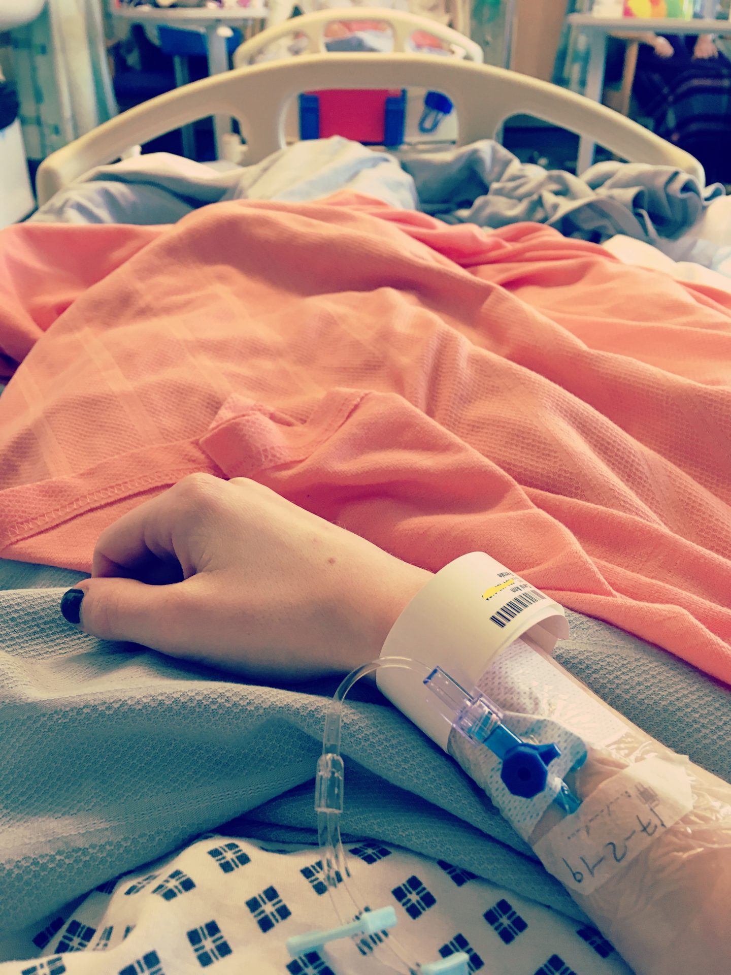An image of me in a hospital bed covered in blankets. I took it looking down so you can see my arm with the IV and legs.