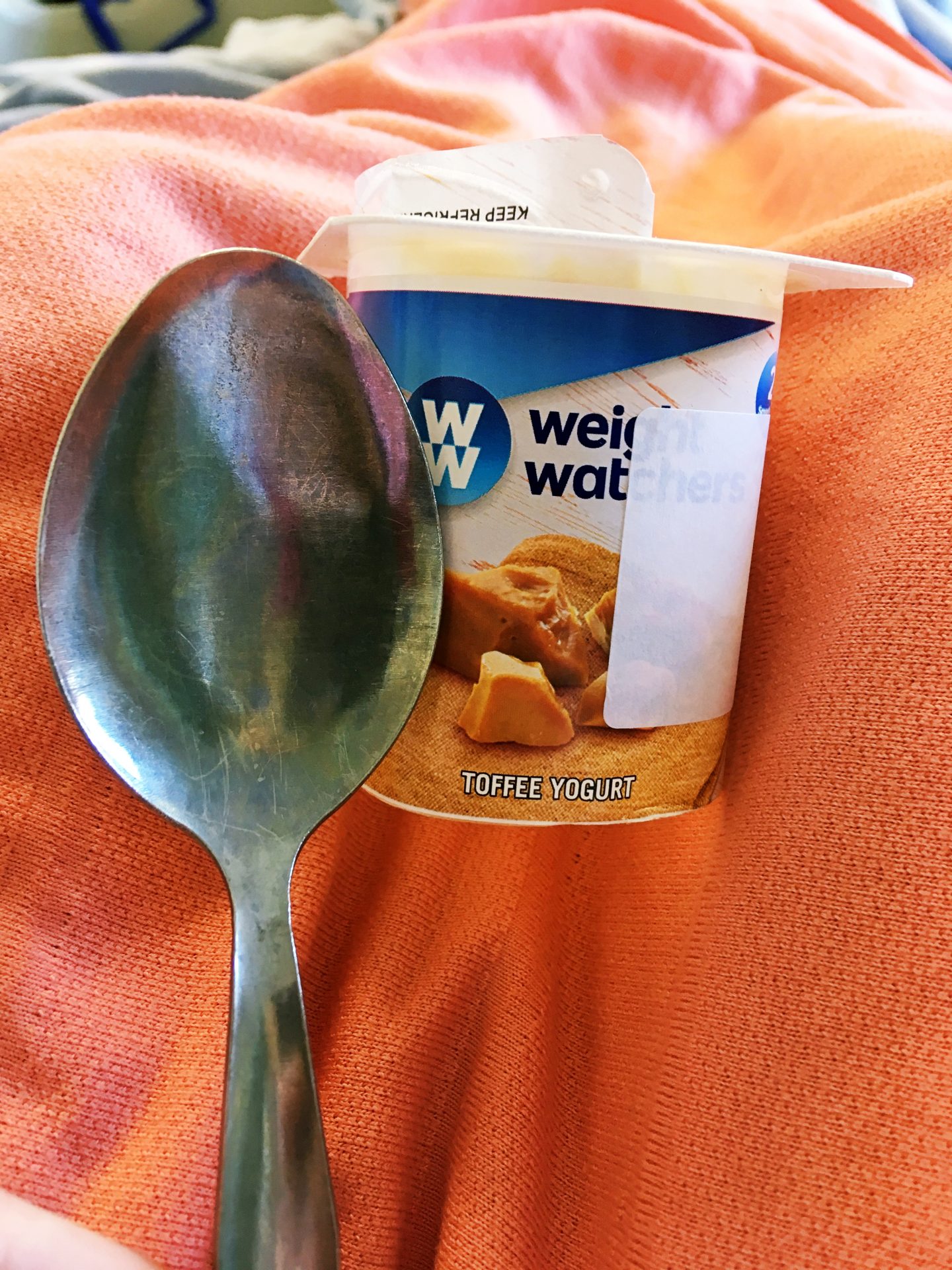 My Weight Watchers yoghurt and the hospital spoon next to it, which is bigger than the pot itself.