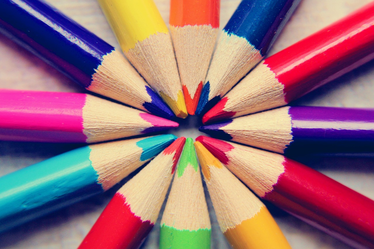 A range of colouring pencils pointing inwards to form a circle.