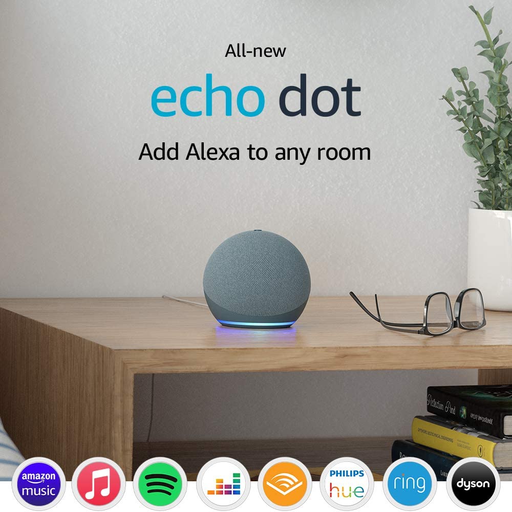 An Amazon promotional image. There's a photo of a desk with a pair of glasses, books and a plant, with an Echo Dot 4th Gen in Twilight Blue sat on the wooden desk. Underneath are logos for the different systems the smart speaker works with on Alexa, such as Amazon Music, Spotify and Audible.