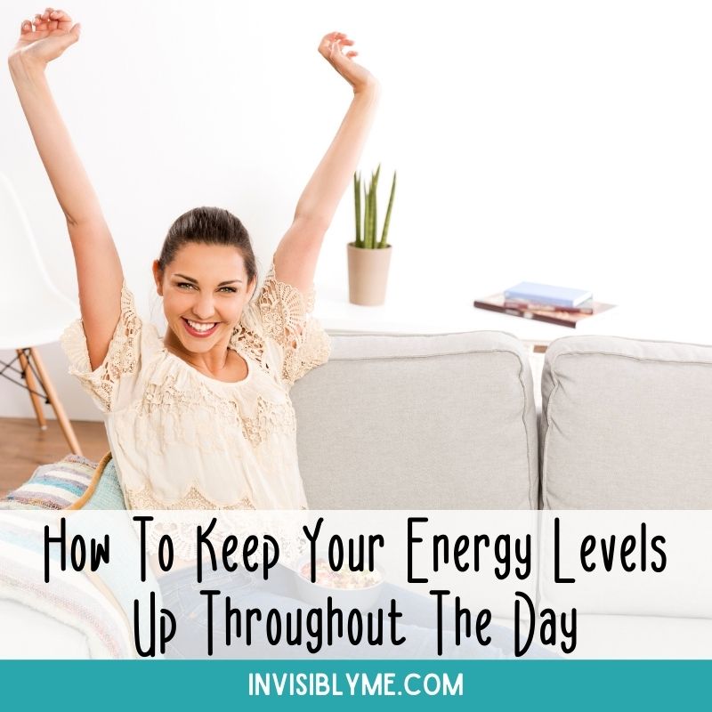 A photo of a woman in a white living room sat on a sofa with her legs up. She's smiling and has her armed stretched up. Below is the title: How To Keep Your Energy Levels Up Throughout The Day