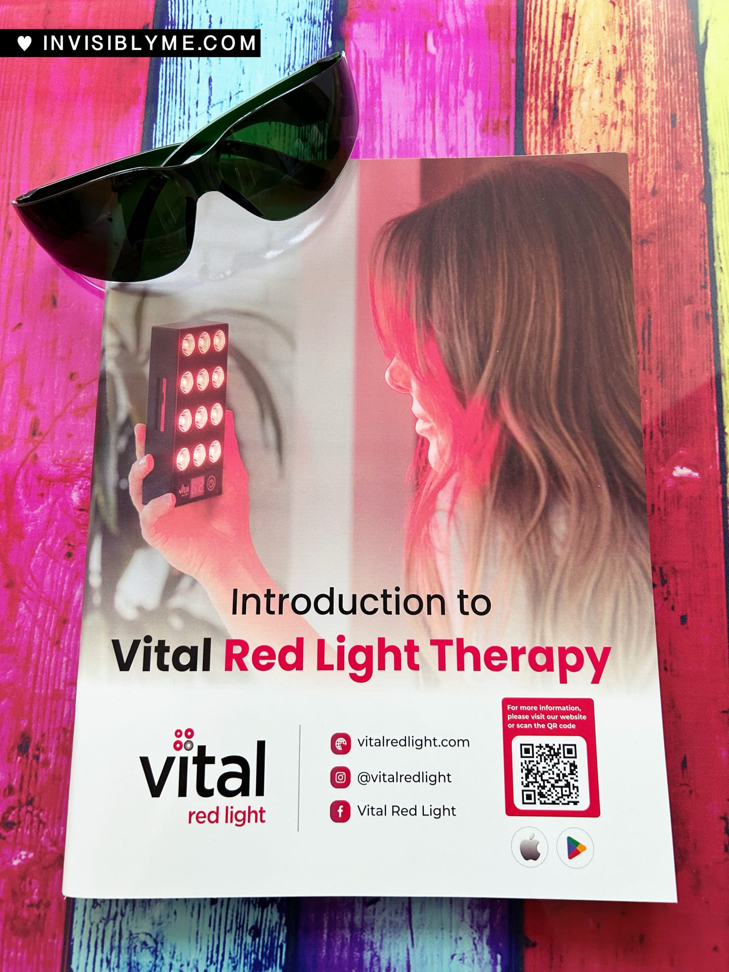 The Vital Red Light glossy booklet and the protective glasses, sat on my colourful glass table.