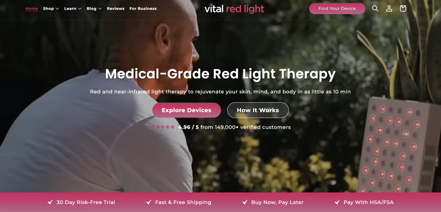 A screenshot of the Vital Red Light Homepage with a man sat in front of the Pro light device. There are links to the blog, reviews, etc, and information on the bar at the bottom that mentions their 30 day risk-free trial, fast and free shipping and buy now pay later.