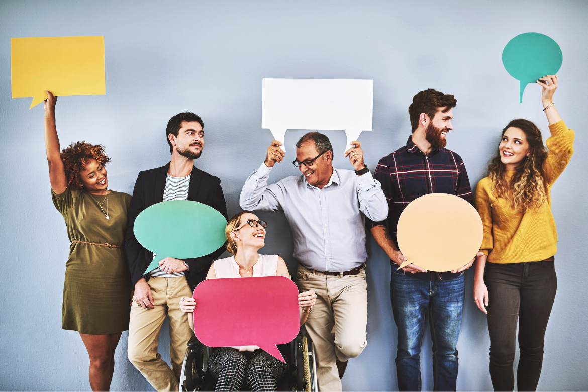 A range of men and women, with one woman in a wheelchair. They're all holding speech bubble cut outs to suggest they're giving their opinions and speaking up.
